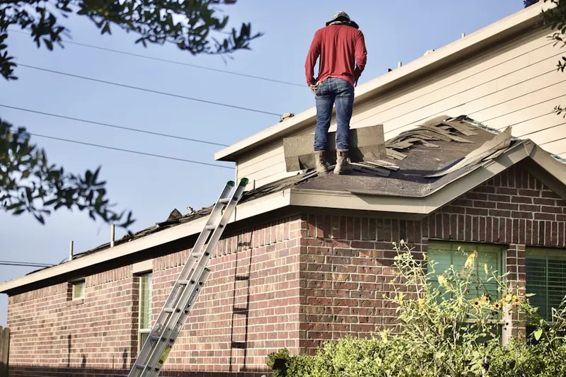 Professional roofer working on a residential roof in Klein Estates
